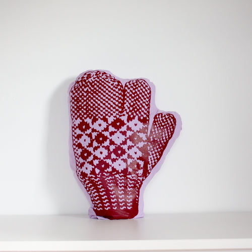 Purple trigger mitten pillow with red print.