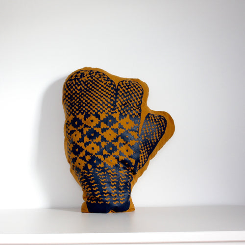 Mustard trigger mitten pillow with blue print.