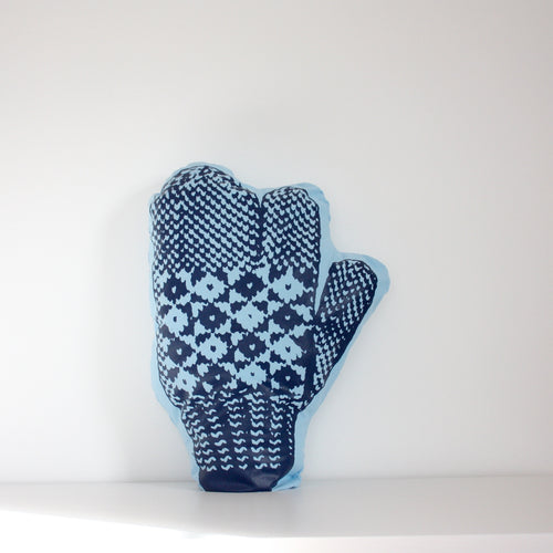 Light blue trigger mitten pillow with dark blue print.